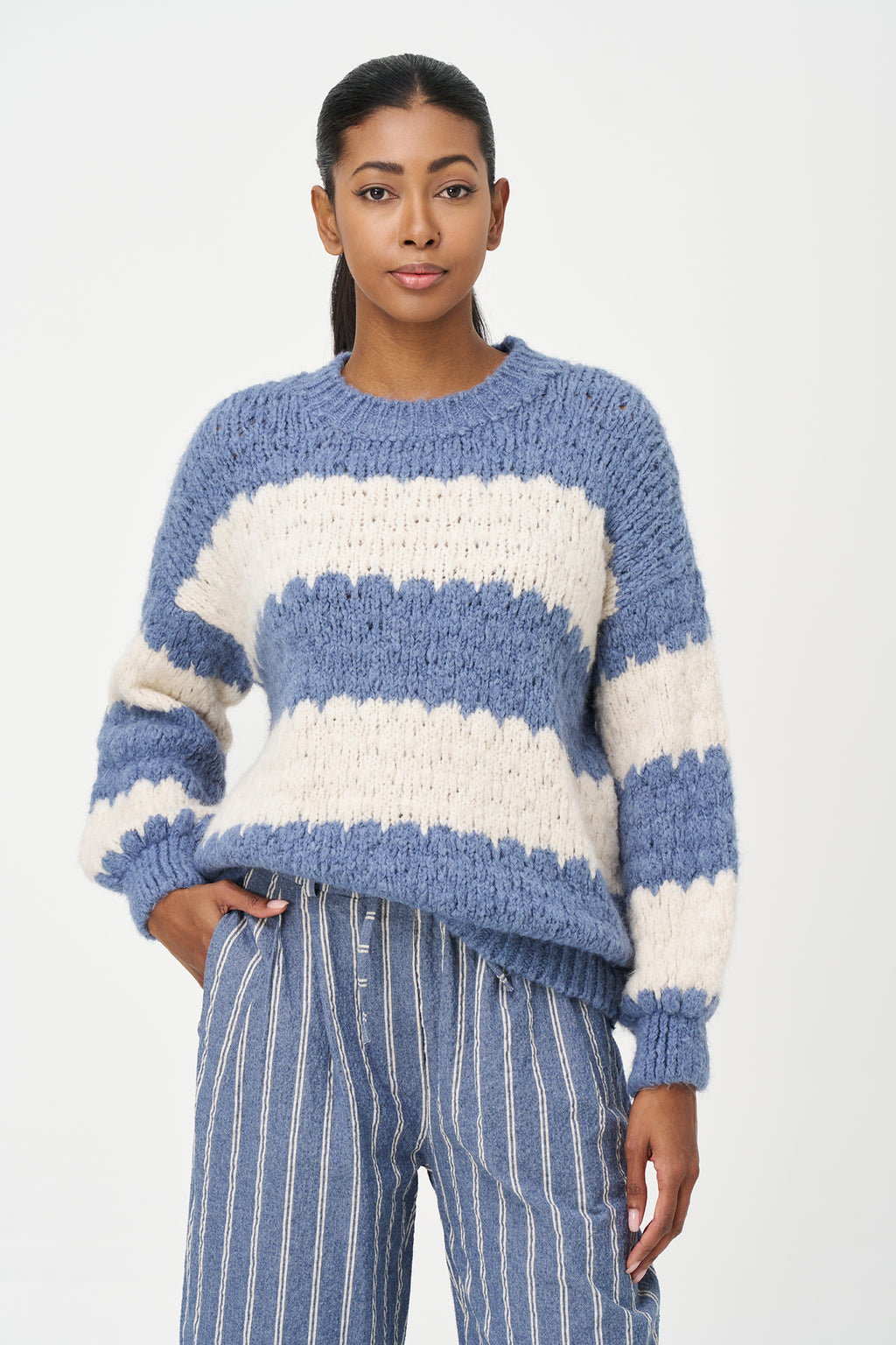 Green-Blue and White striped sweater in soft acrylic blend with a fuzzy texture and relaxed fit, perfect for layering on chilly days.