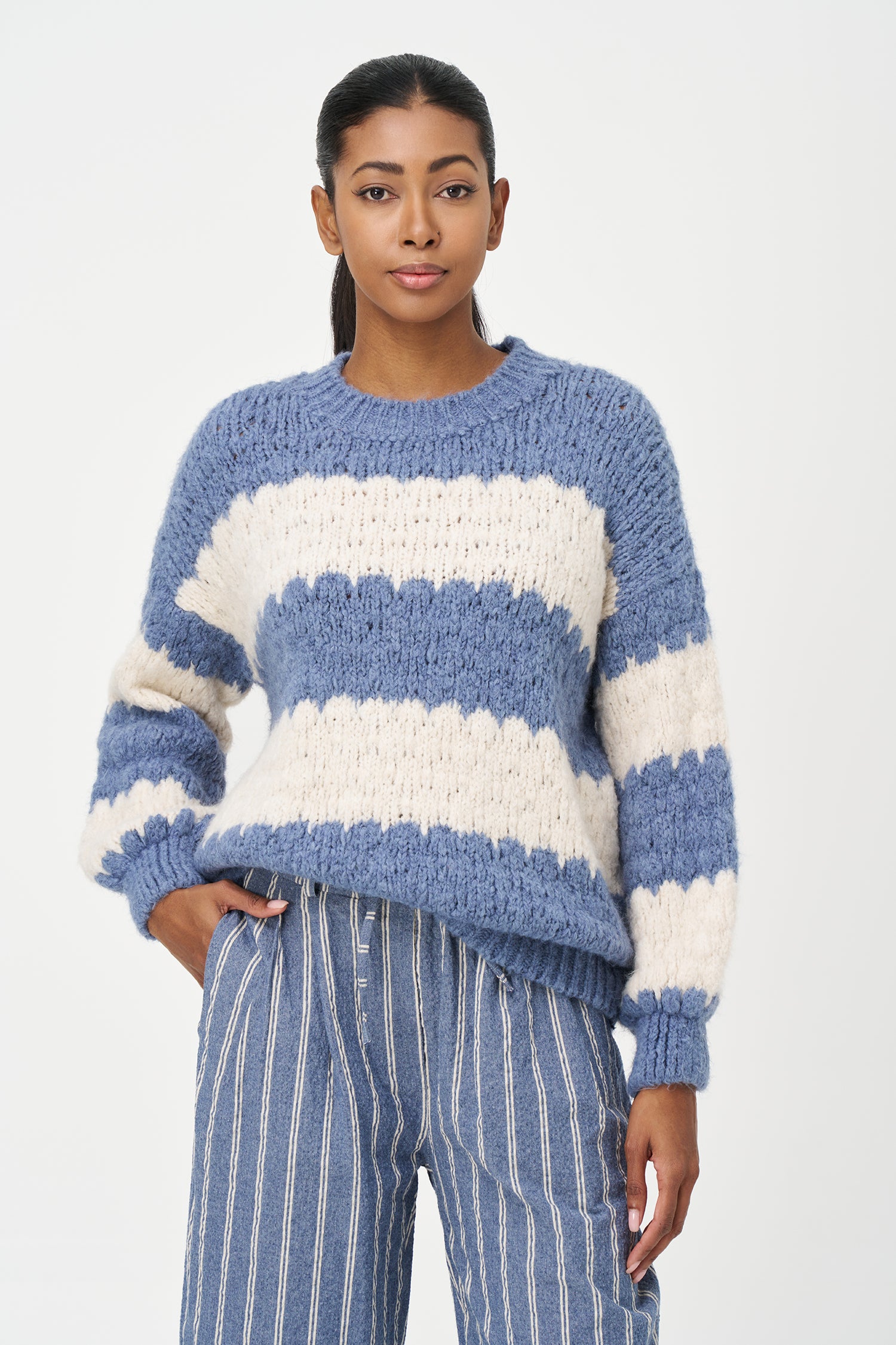 Green-Blue and White striped sweater in soft acrylic blend with a fuzzy texture and relaxed fit, perfect for layering on chilly days.