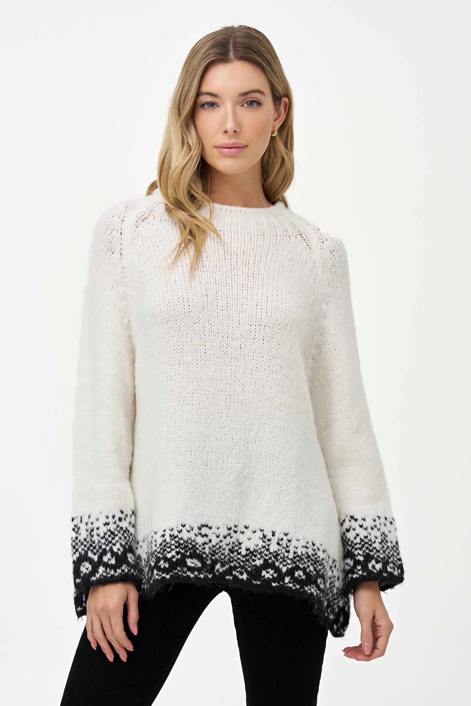 White knit sweater with black jacquard trim, soft wool blend texture and relaxed silhouette ideal for layering in cool weather.