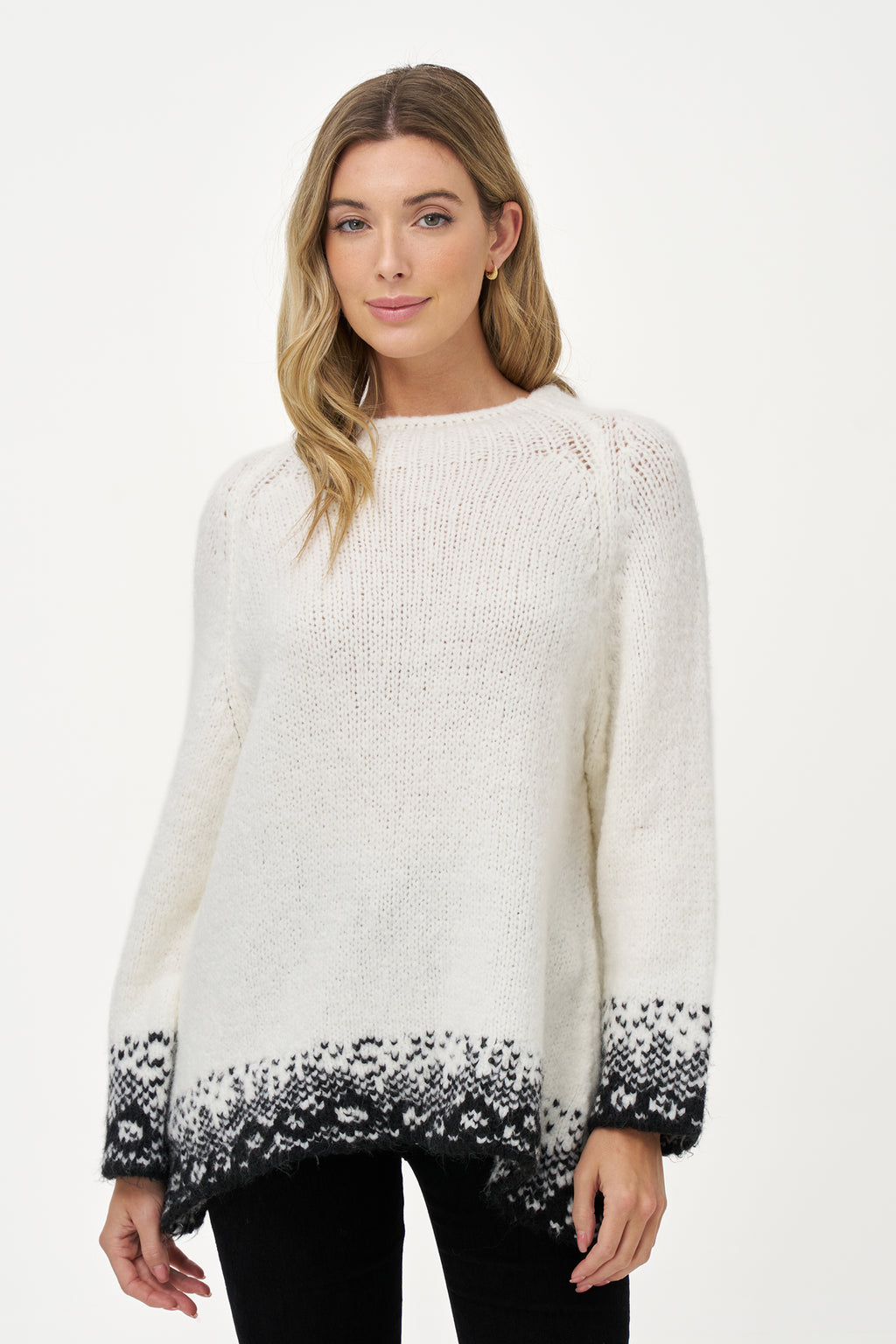 White knit sweater with black jacquard trim, soft wool blend texture and relaxed silhouette ideal for layering in cool weather.