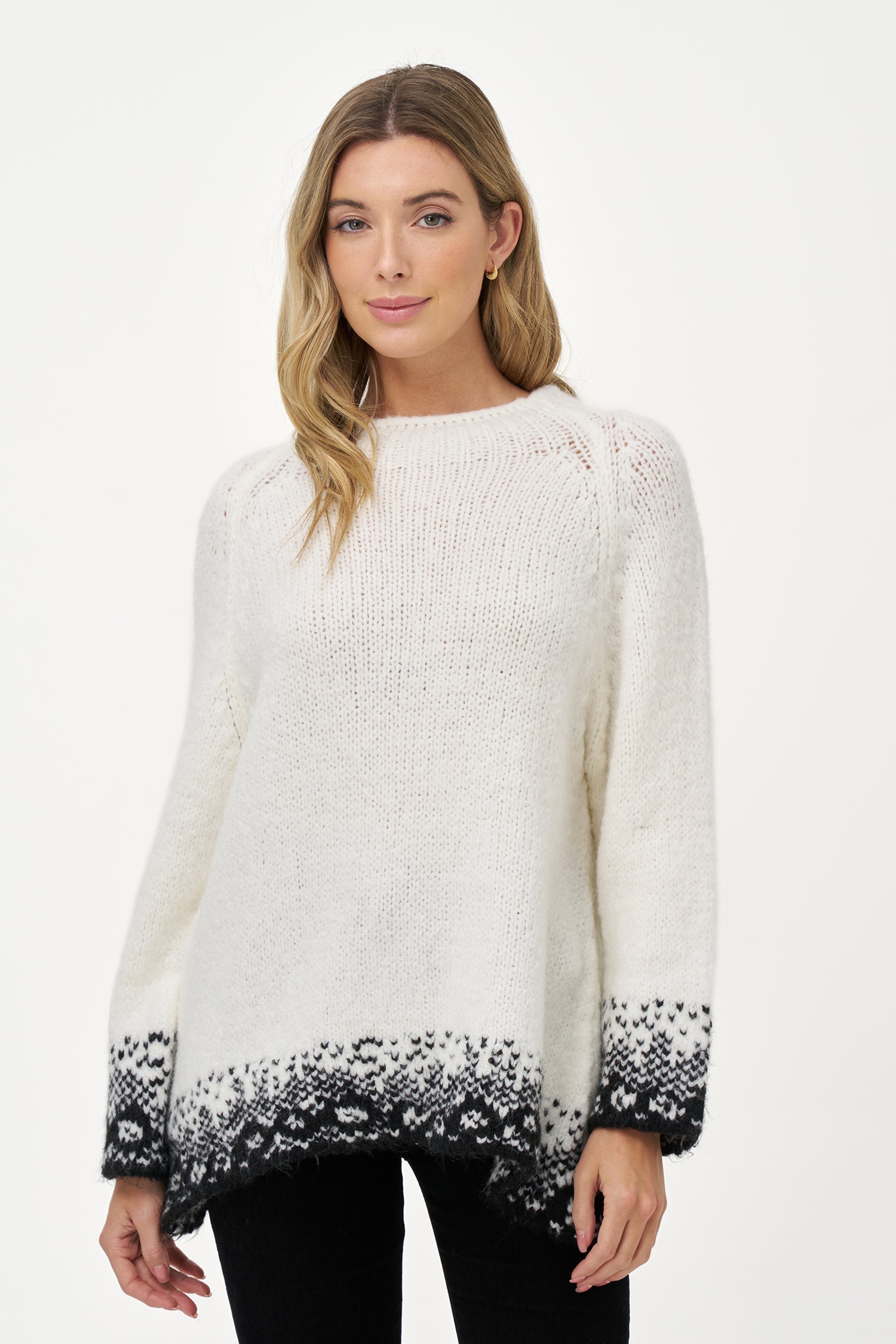 White knit sweater with black jacquard trim, soft wool blend texture and relaxed silhouette ideal for layering in cool weather.