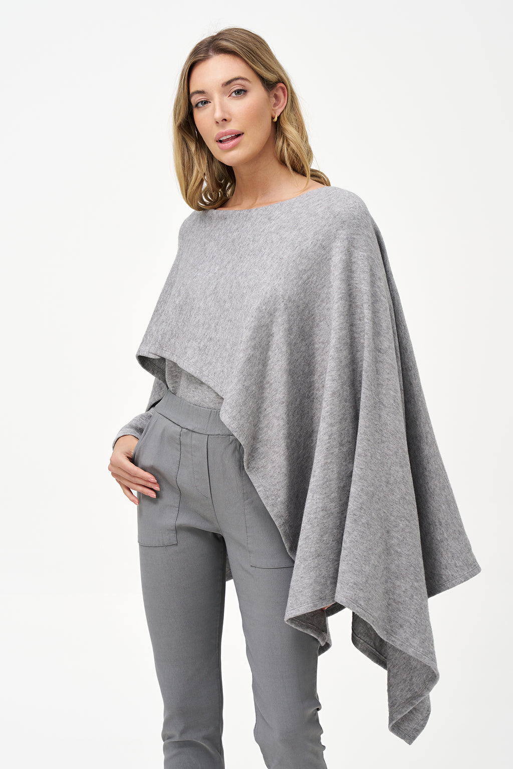 Yellow viscose-blend asymmetrical poncho-style top with fluid drape, stretch fabric, and layered hemline for modern elegance.