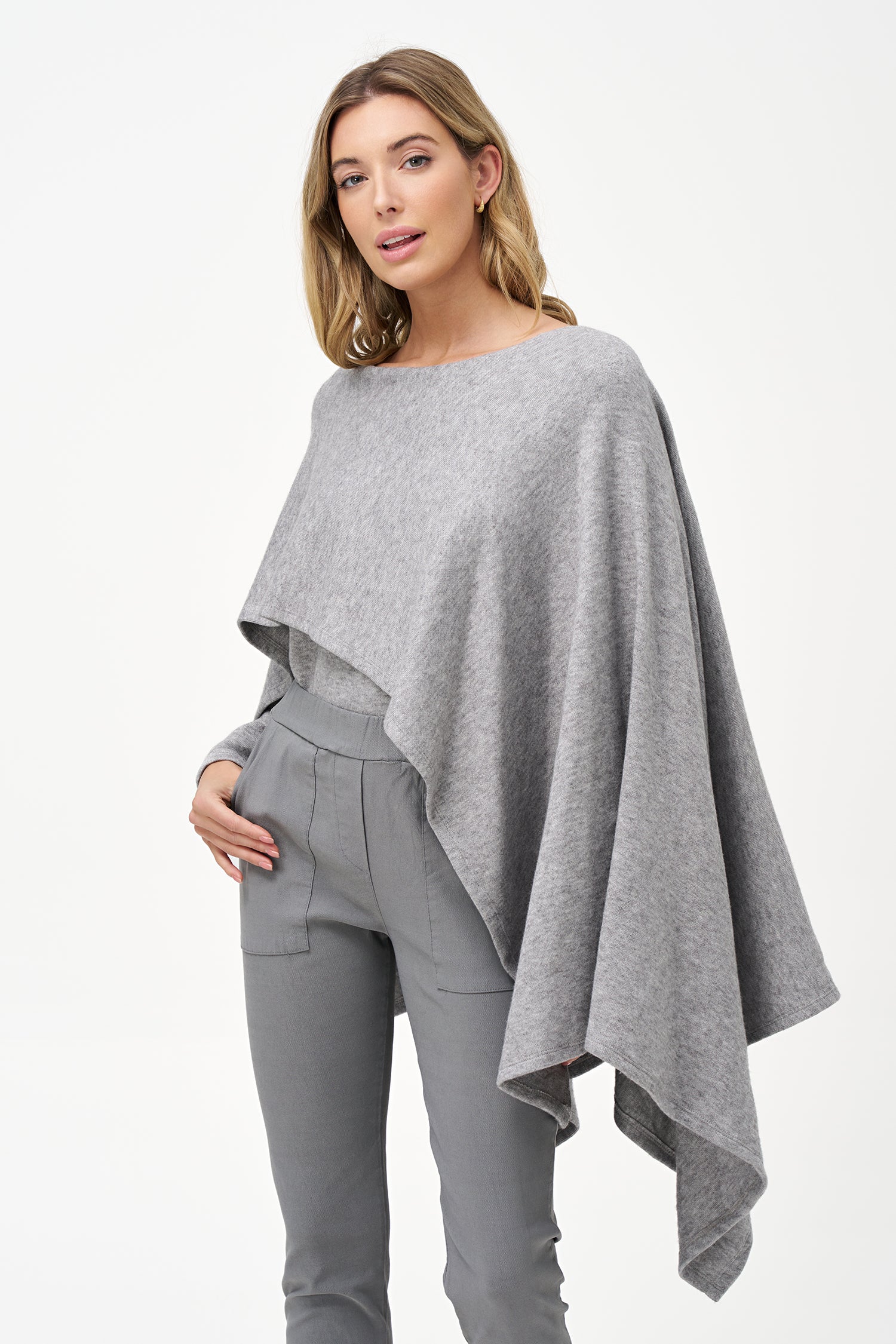 Yellow viscose-blend asymmetrical poncho-style top with fluid drape, stretch fabric, and layered hemline for modern elegance.