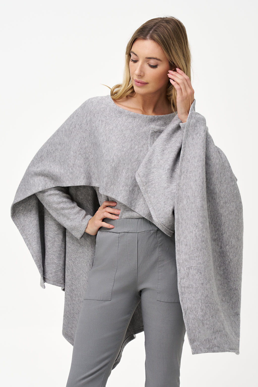 Yellow viscose-blend asymmetrical poncho-style top with fluid drape, stretch fabric, and layered hemline for modern elegance.