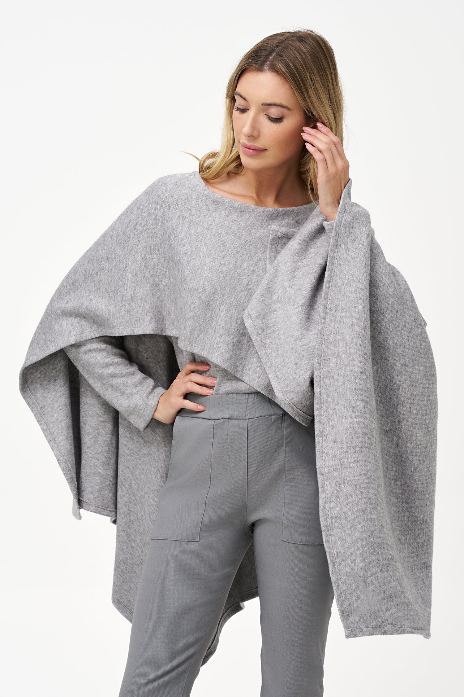 Yellow viscose-blend asymmetrical poncho-style top with fluid drape, stretch fabric, and layered hemline for modern elegance.