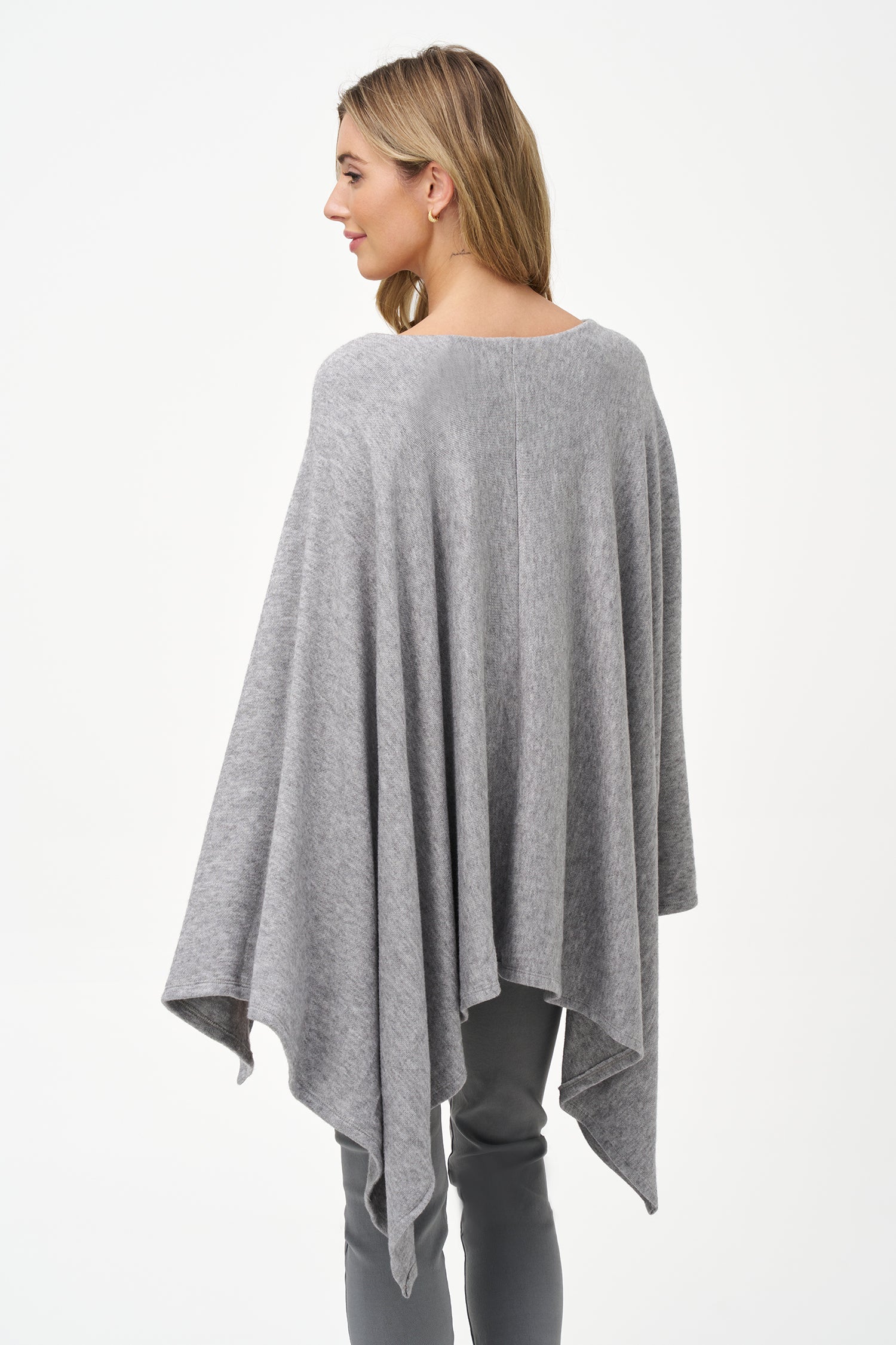 Yellow viscose-blend asymmetrical poncho-style top with fluid drape, stretch fabric, and layered hemline for modern elegance.