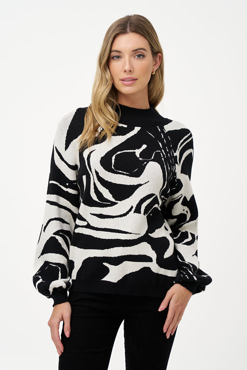 Women's black and white abstract knit sweater with high neckline and puff sleeves in soft viscose blend, perfect for day-to-night outfits and statement layering.
