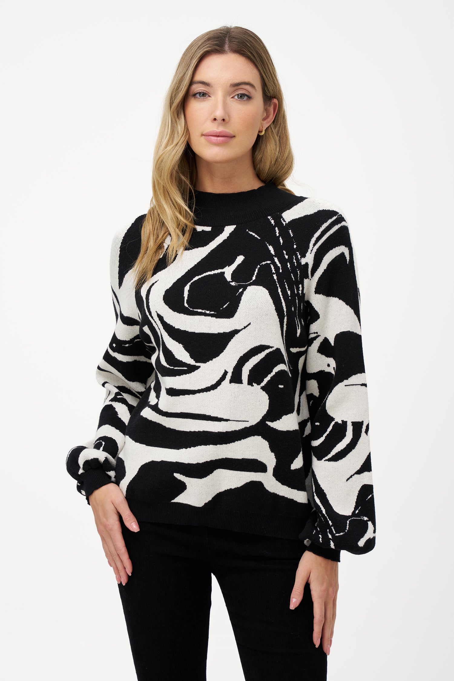 Women's black and white abstract knit sweater with high neckline and puff sleeves in soft viscose blend, perfect for day-to-night outfits and statement layering.