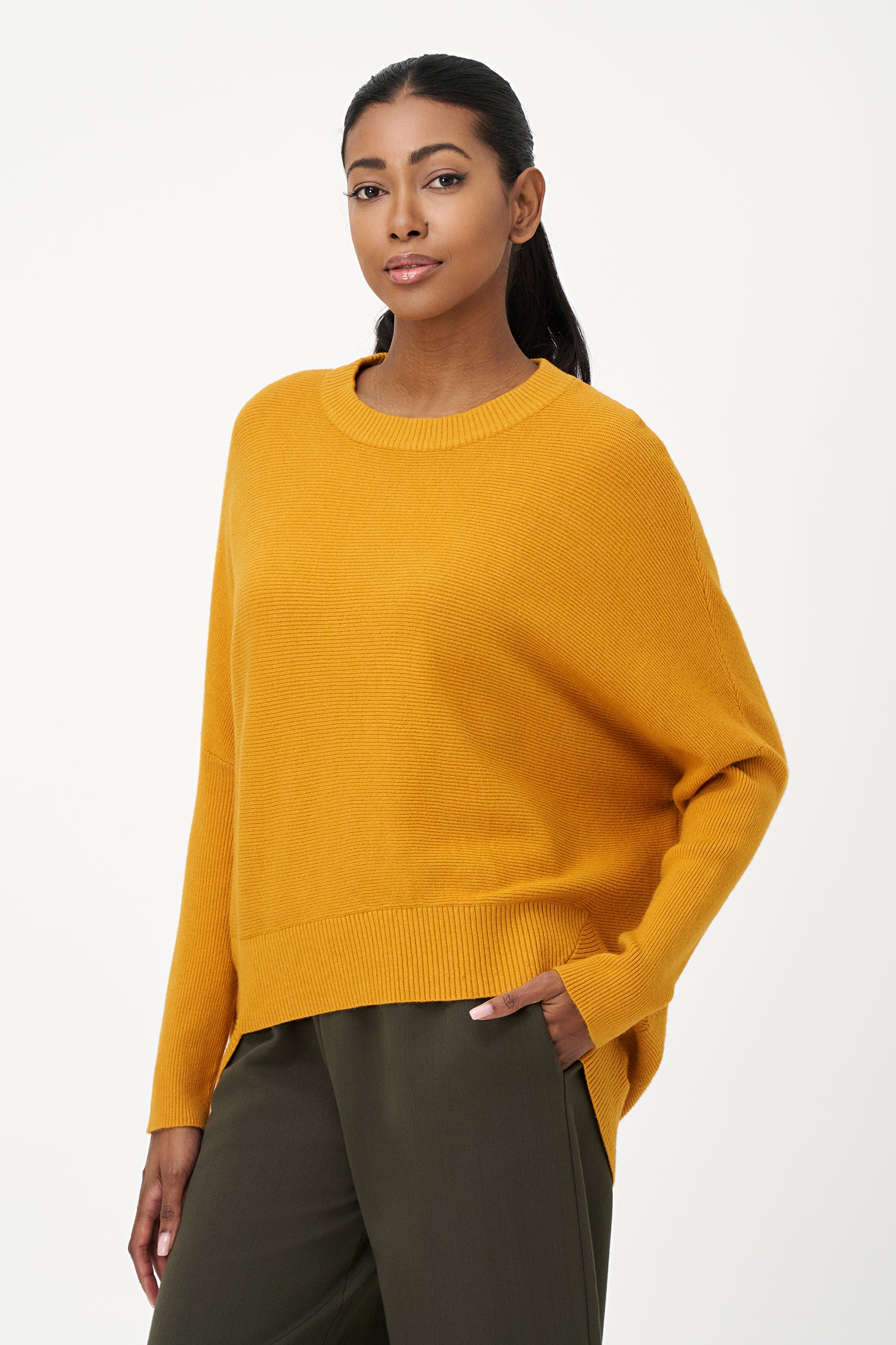 Honey yellow knit sweater with long sleeves and ribbed hem, made in soft viscose wool blend with relaxed fit and clean neckline