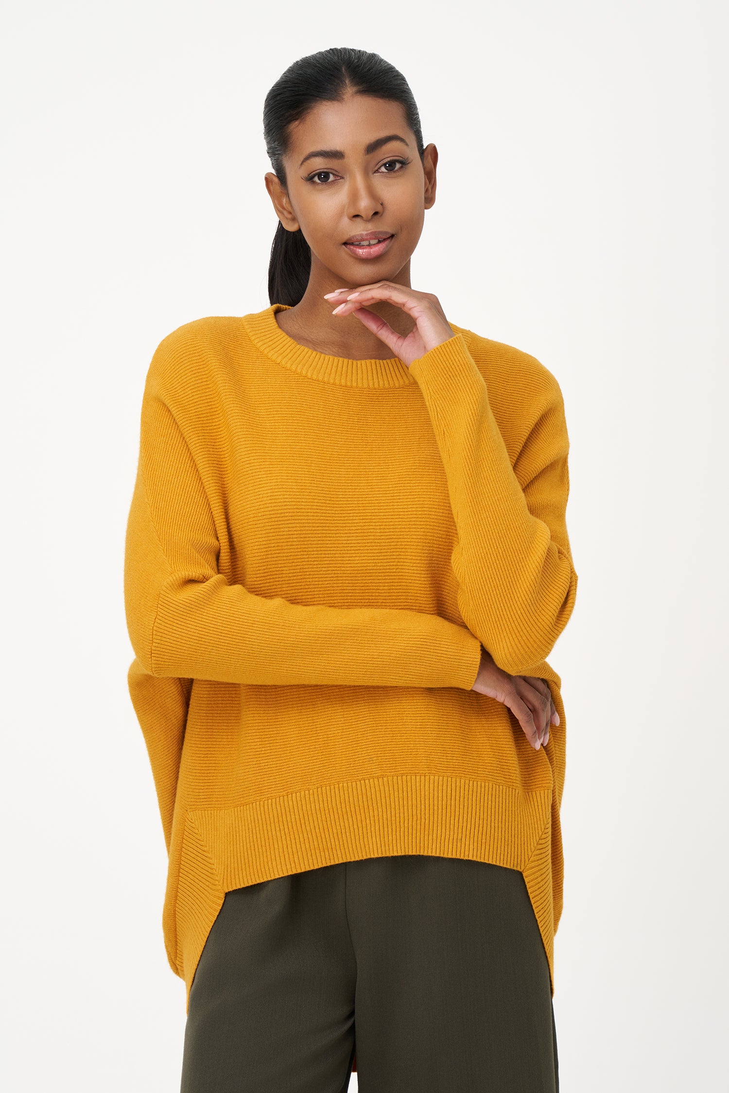 Honey yellow knit sweater with long sleeves and ribbed hem, made in soft viscose wool blend with relaxed fit and clean neckline