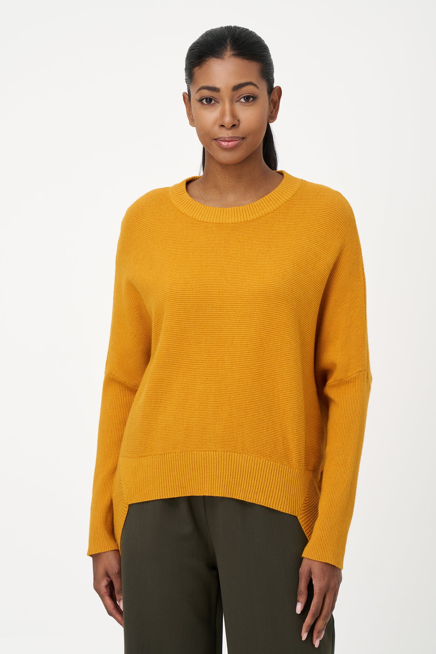 Honey yellow knit sweater with long sleeves and ribbed hem, made in soft viscose wool blend with relaxed fit and clean neckline