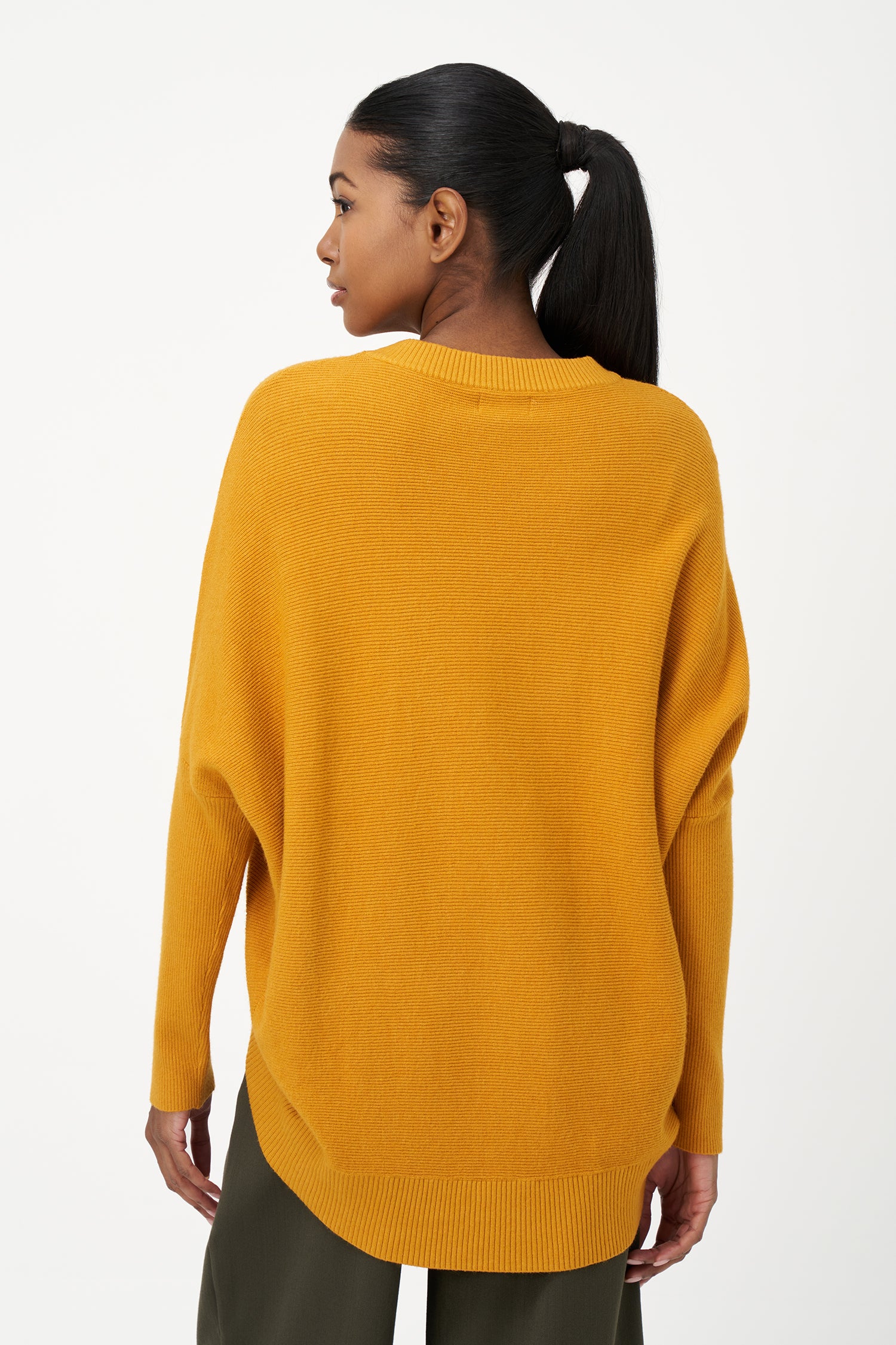 Honey yellow knit sweater with long sleeves and ribbed hem, made in soft viscose wool blend with relaxed fit and clean neckline