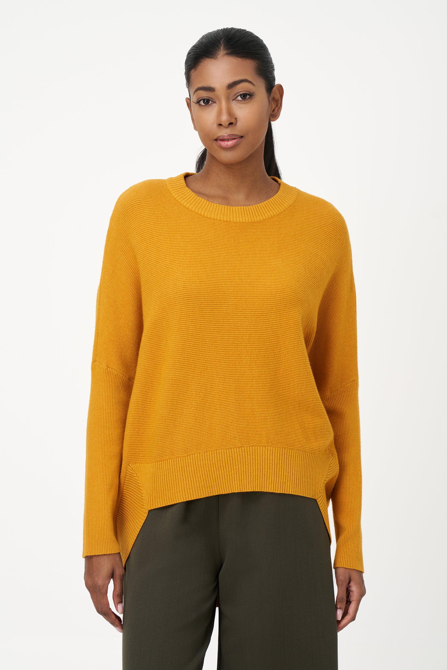 Honey yellow knit sweater with long sleeves and ribbed hem, made in soft viscose wool blend with relaxed fit and clean neckline