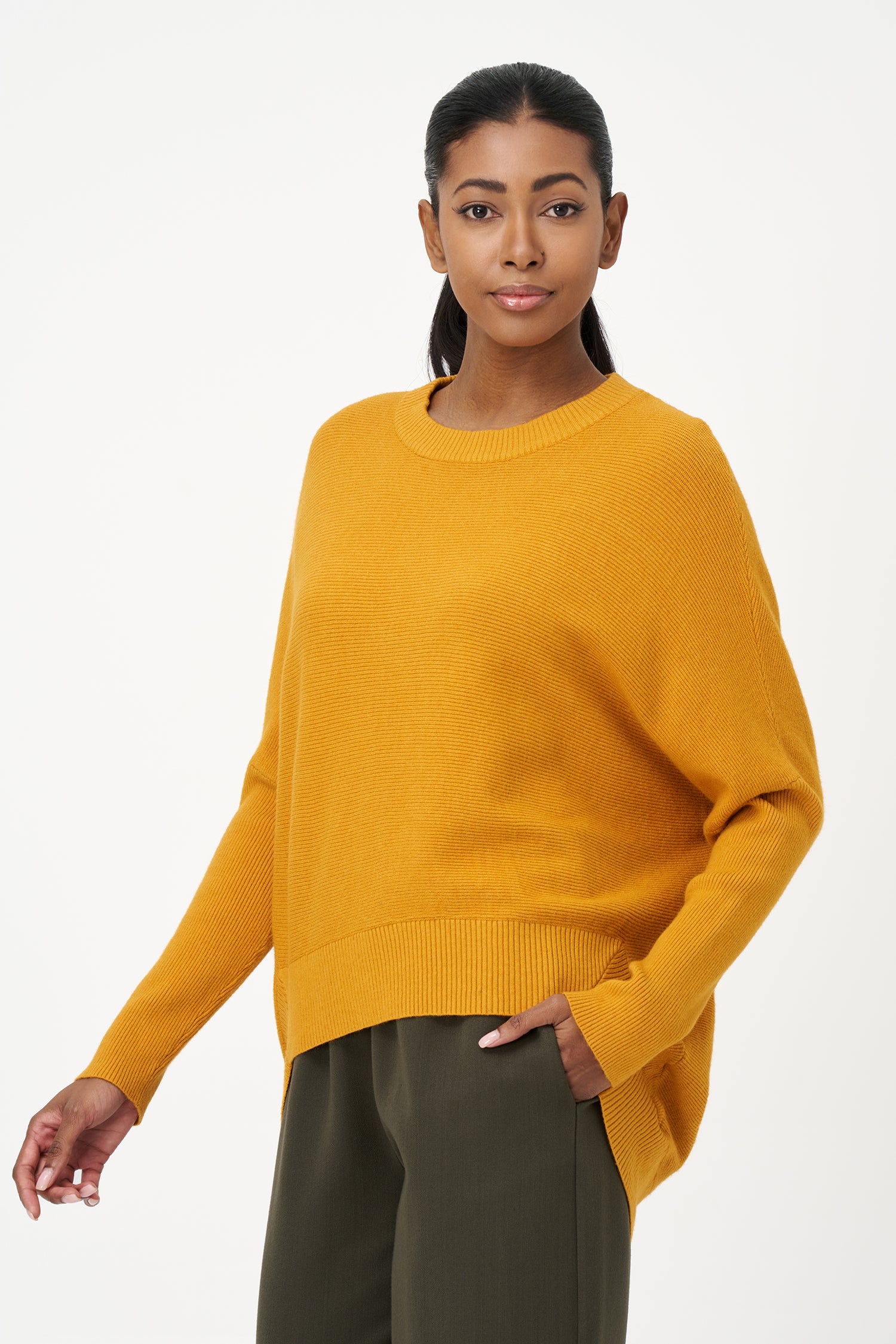 Honey yellow knit sweater with long sleeves and ribbed hem, made in soft viscose wool blend with relaxed fit and clean neckline