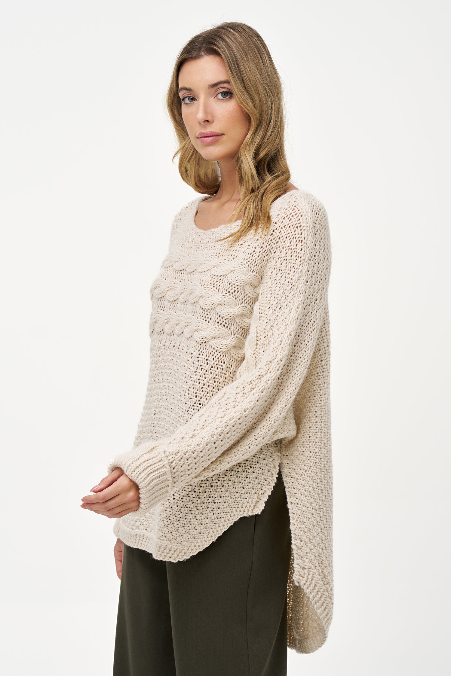 Cream White cable knit sweater with textured weave, round neck, and long sleeves, made of cozy acrylic wool blend with relaxed silhouette