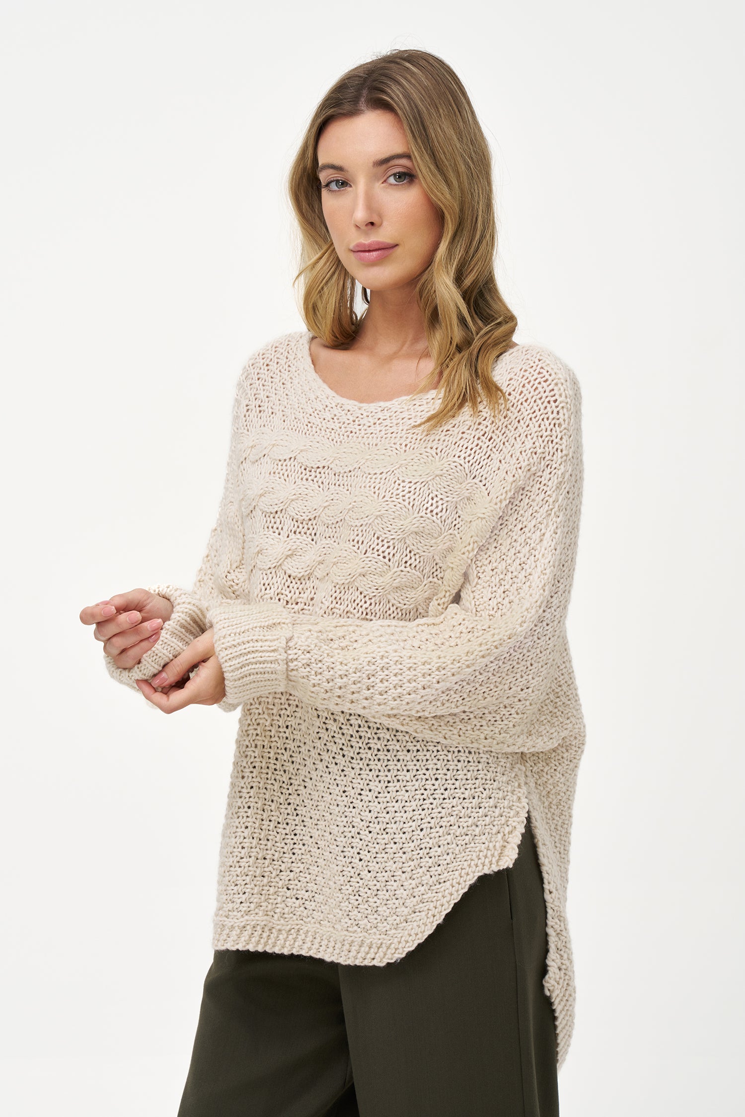 Cream White cable knit sweater with textured weave, round neck, and long sleeves, made of cozy acrylic wool blend with relaxed silhouette