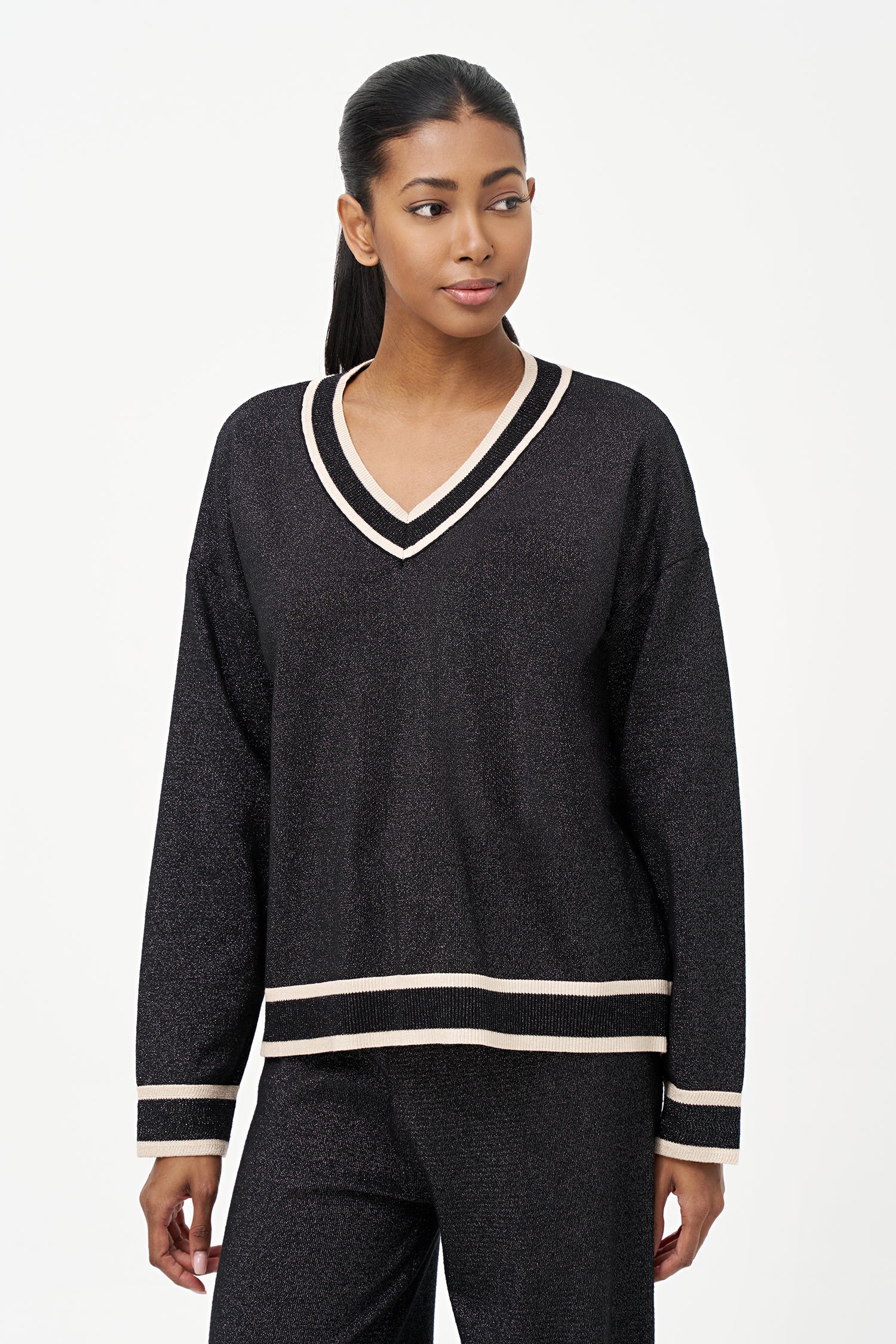 Shimmer knit sweater with V-neck and contrast trim details, adding a refined touch to both daytime and evening looks.