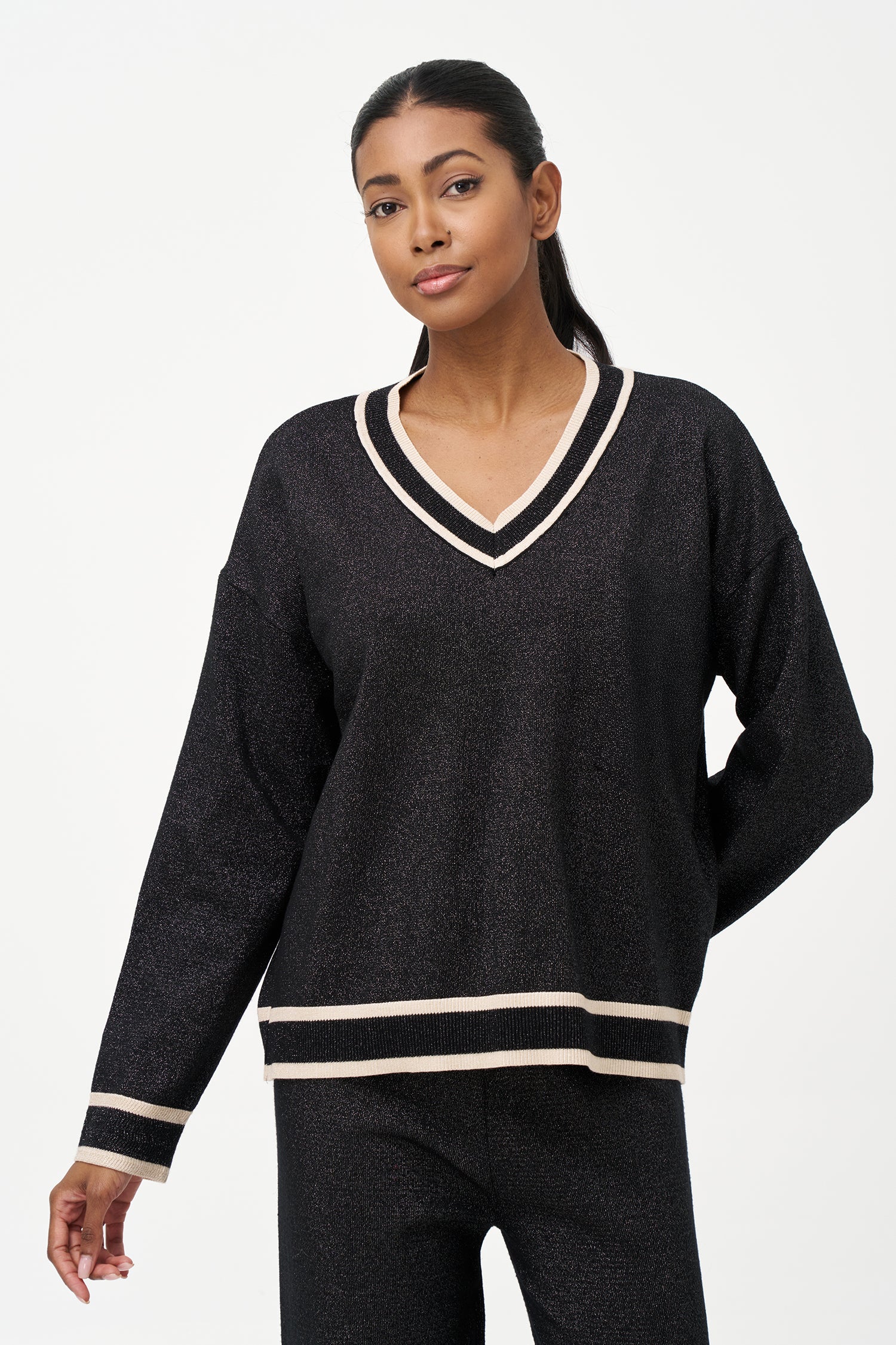 Shimmer knit sweater with V-neck and contrast trim details, adding a refined touch to both daytime and evening looks.