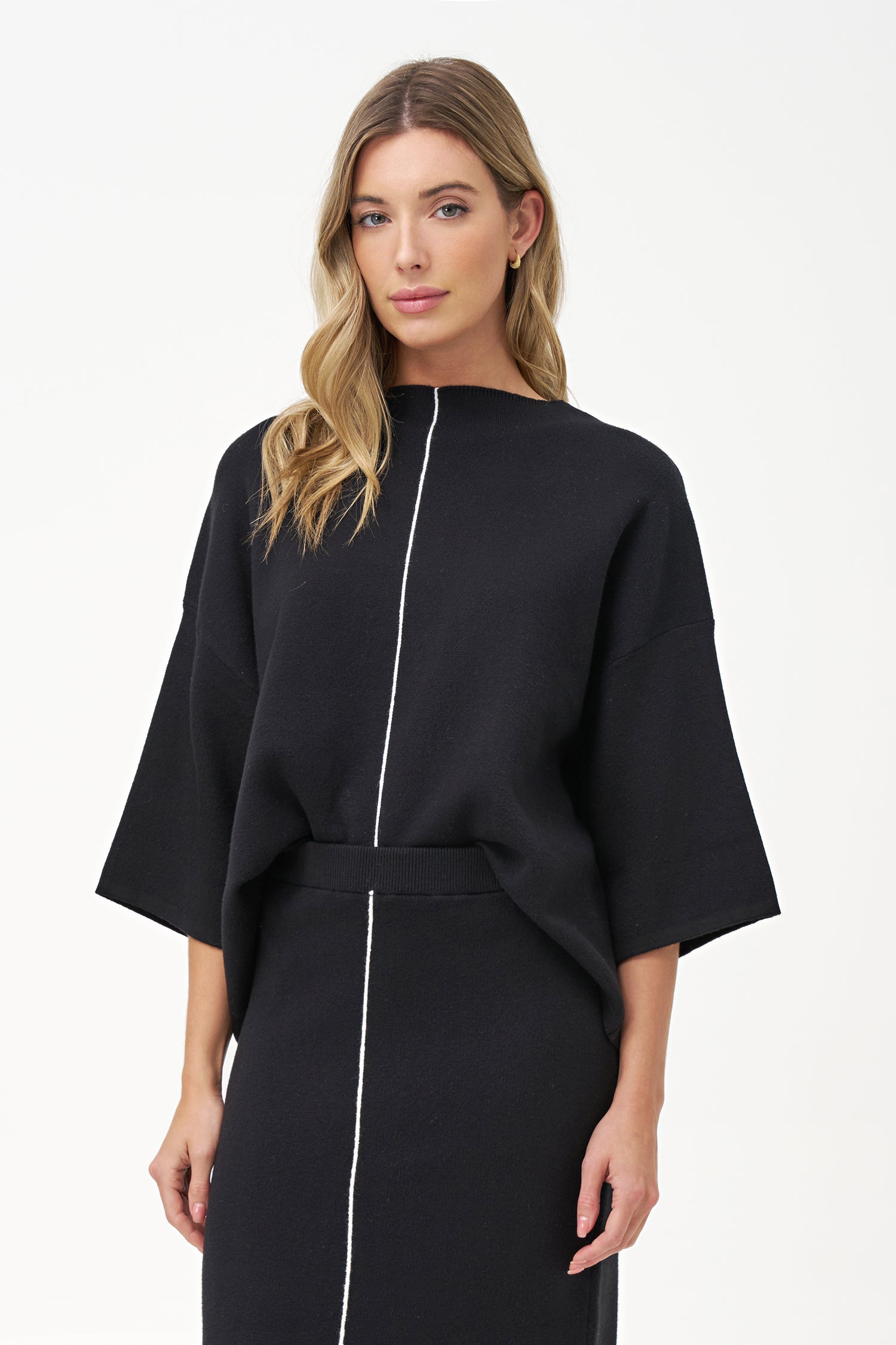 Minimalist wide-sleeve pullover with contrast center seam, featuring a relaxed fit and refined drape for versatile everyday styling.