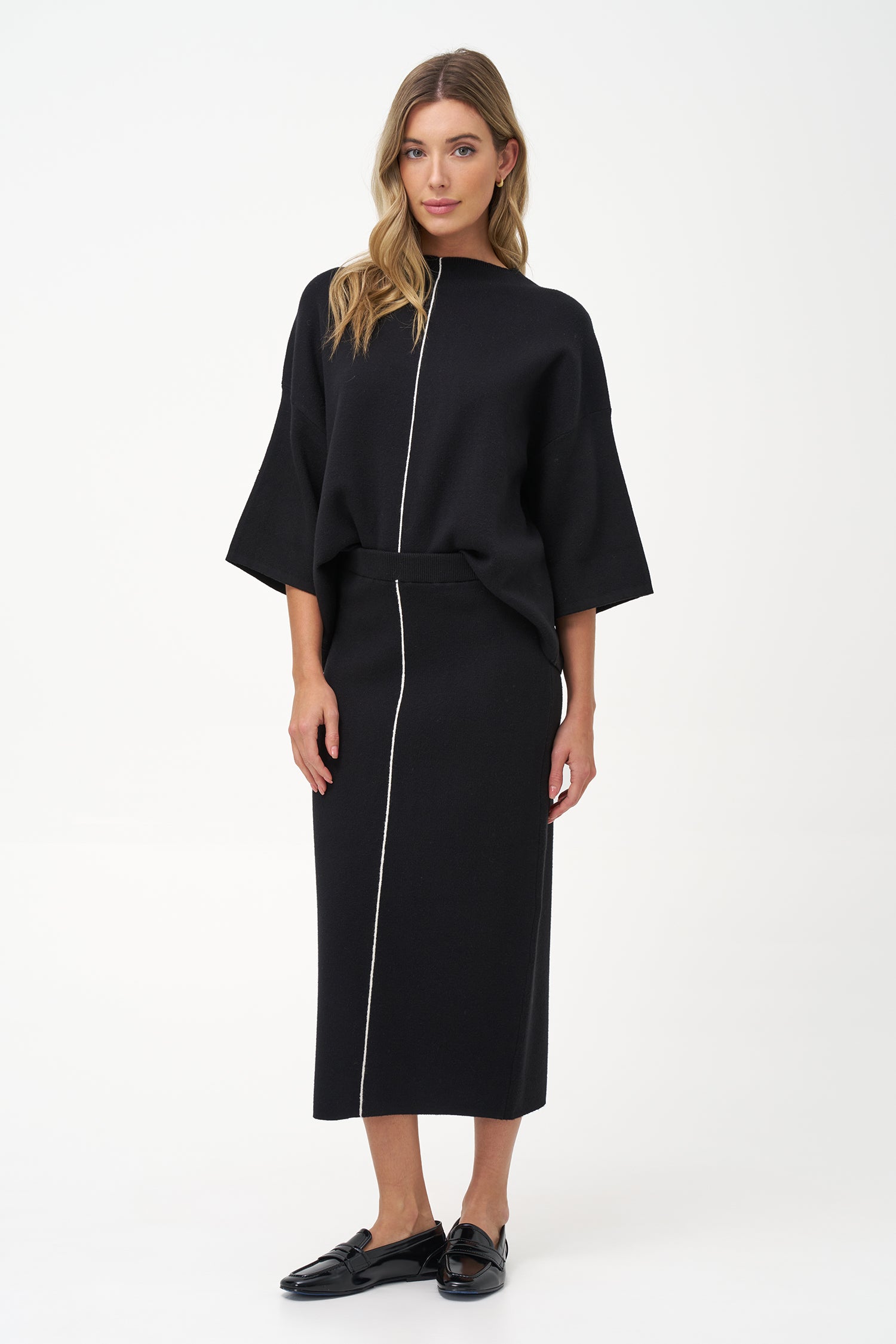 Minimalist wide-sleeve pullover with contrast center seam, featuring a relaxed fit and refined drape for versatile everyday styling.