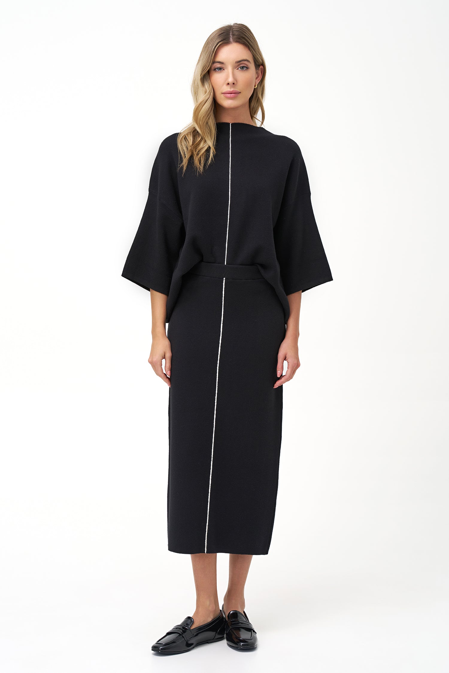Minimalist wide-sleeve pullover with contrast center seam, featuring a relaxed fit and refined drape for versatile everyday styling.