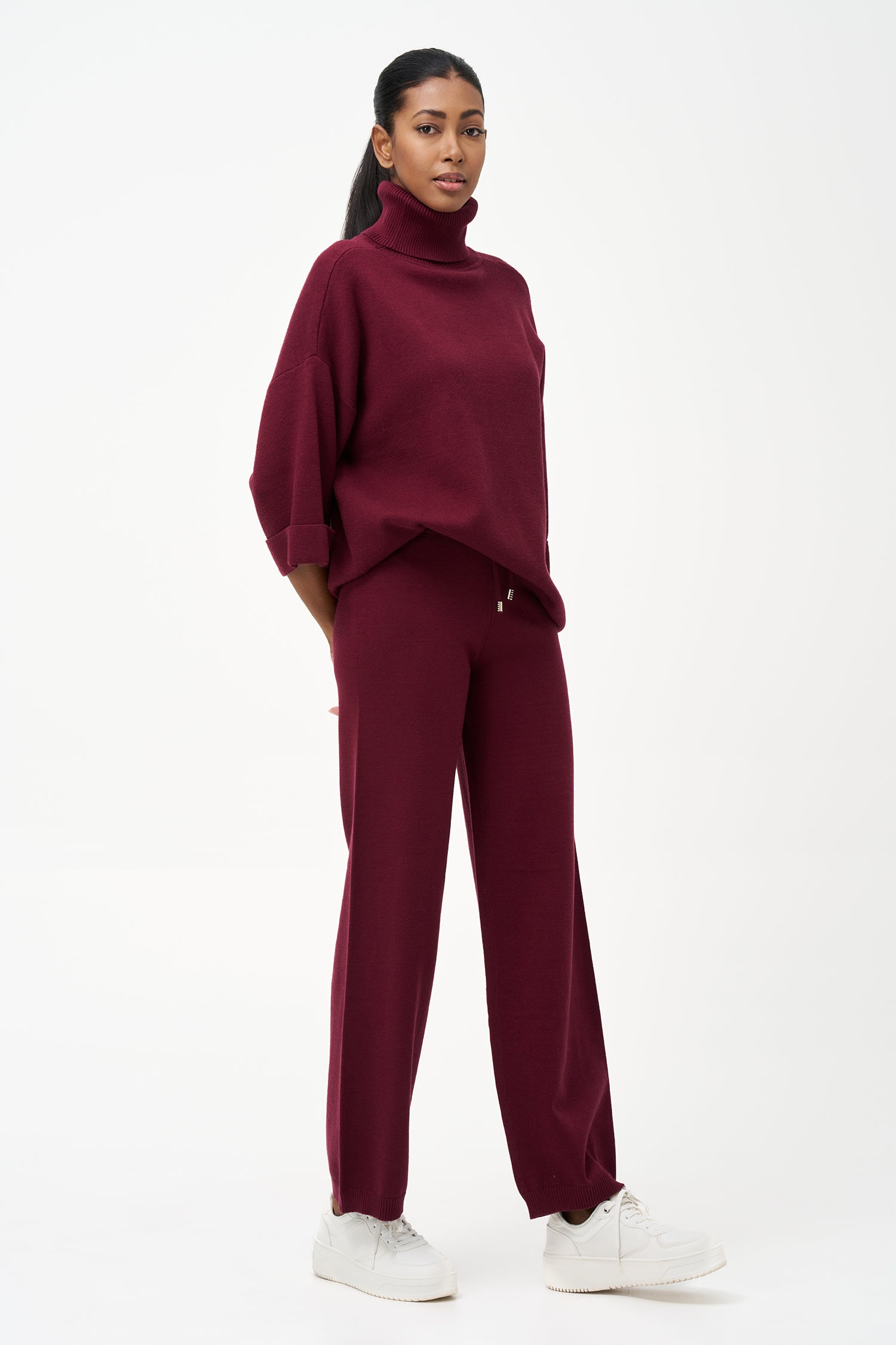 red turtleneck top with wide 3/4 sleeves, folded cuffs, and a structured silhouette for casual or polished styling.