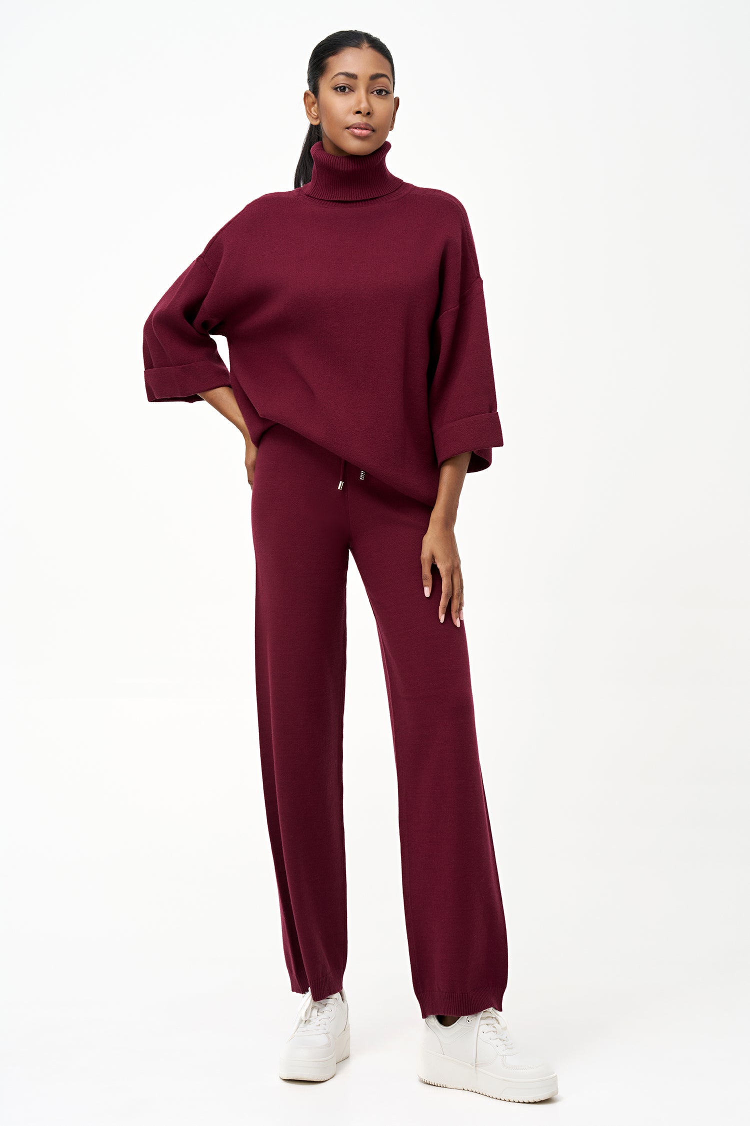 red turtleneck top with wide 3/4 sleeves, folded cuffs, and a structured silhouette for casual or polished styling.