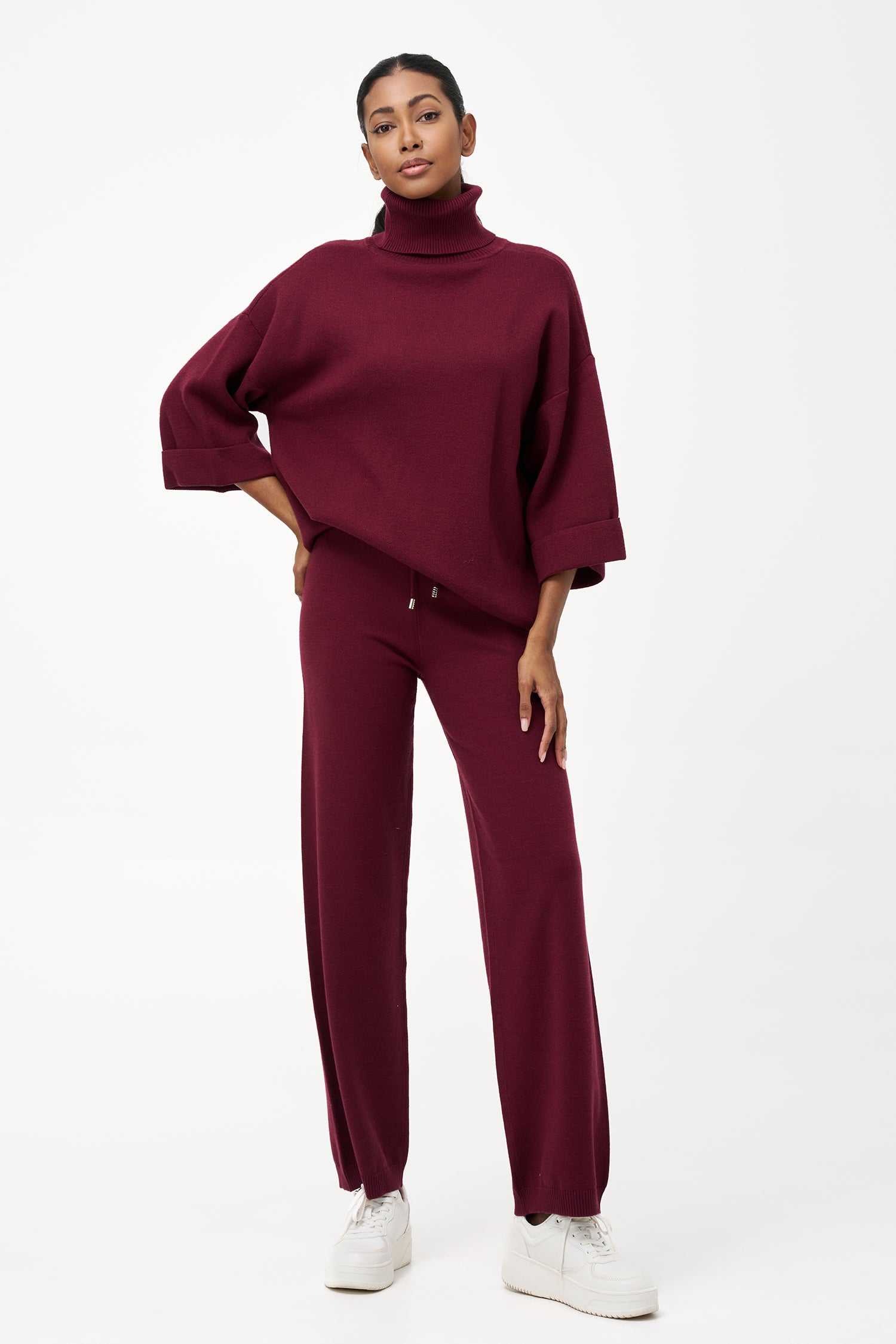 red turtleneck top with wide 3/4 sleeves, folded cuffs, and a structured silhouette for casual or polished styling.