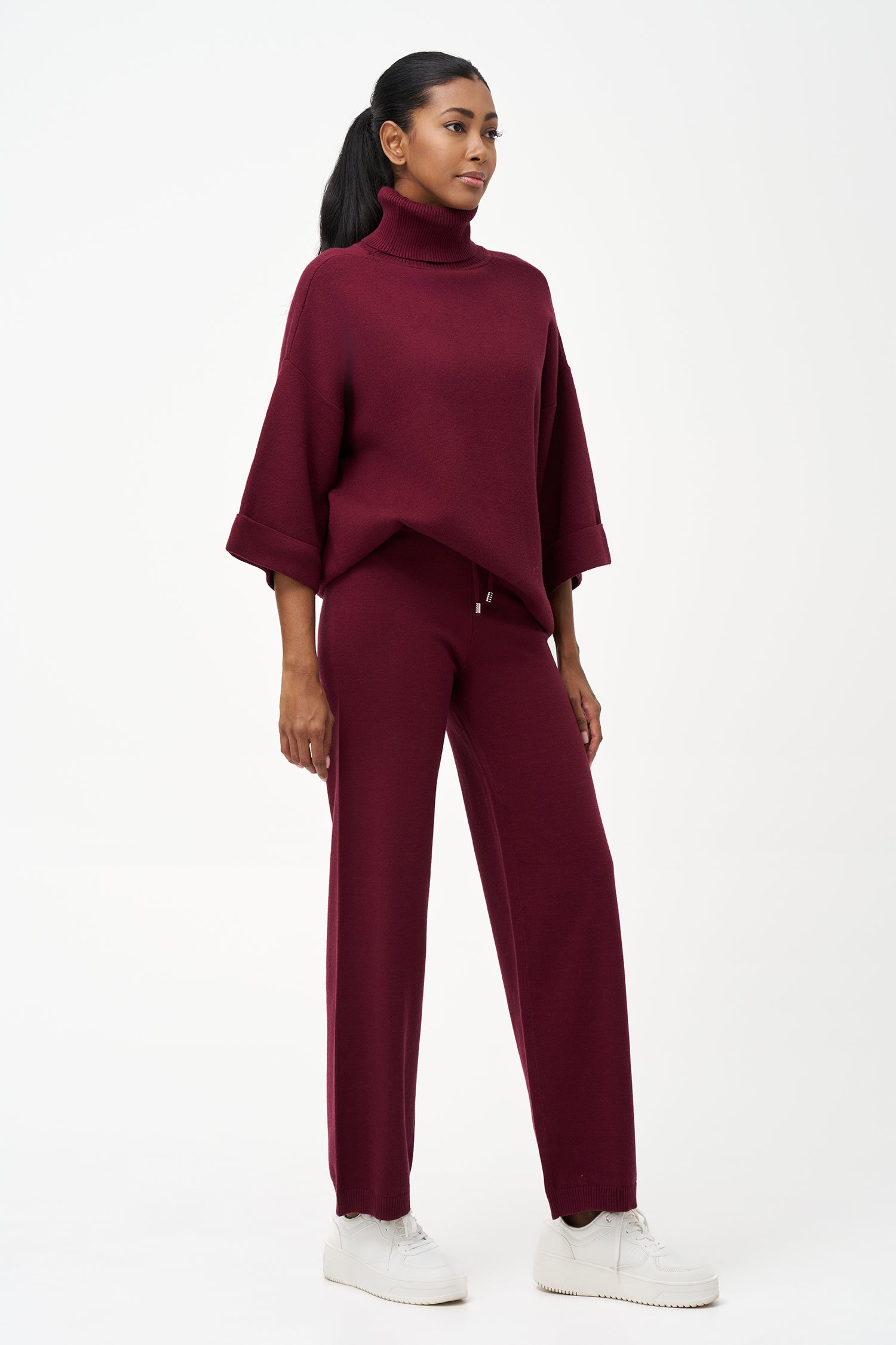 red turtleneck top with wide 3/4 sleeves, folded cuffs, and a structured silhouette for casual or polished styling.