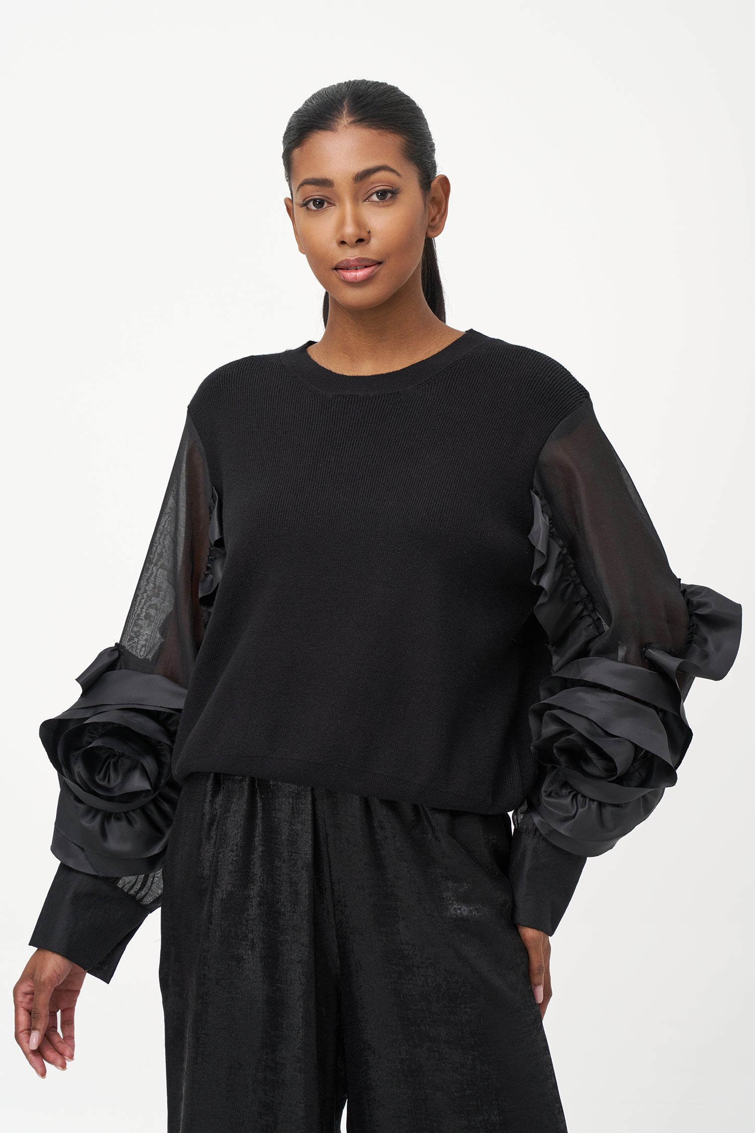 Black crew neck sweater with statement ruffled satin sleeves and contrast textures for a bold, fashion-forward silhouette.