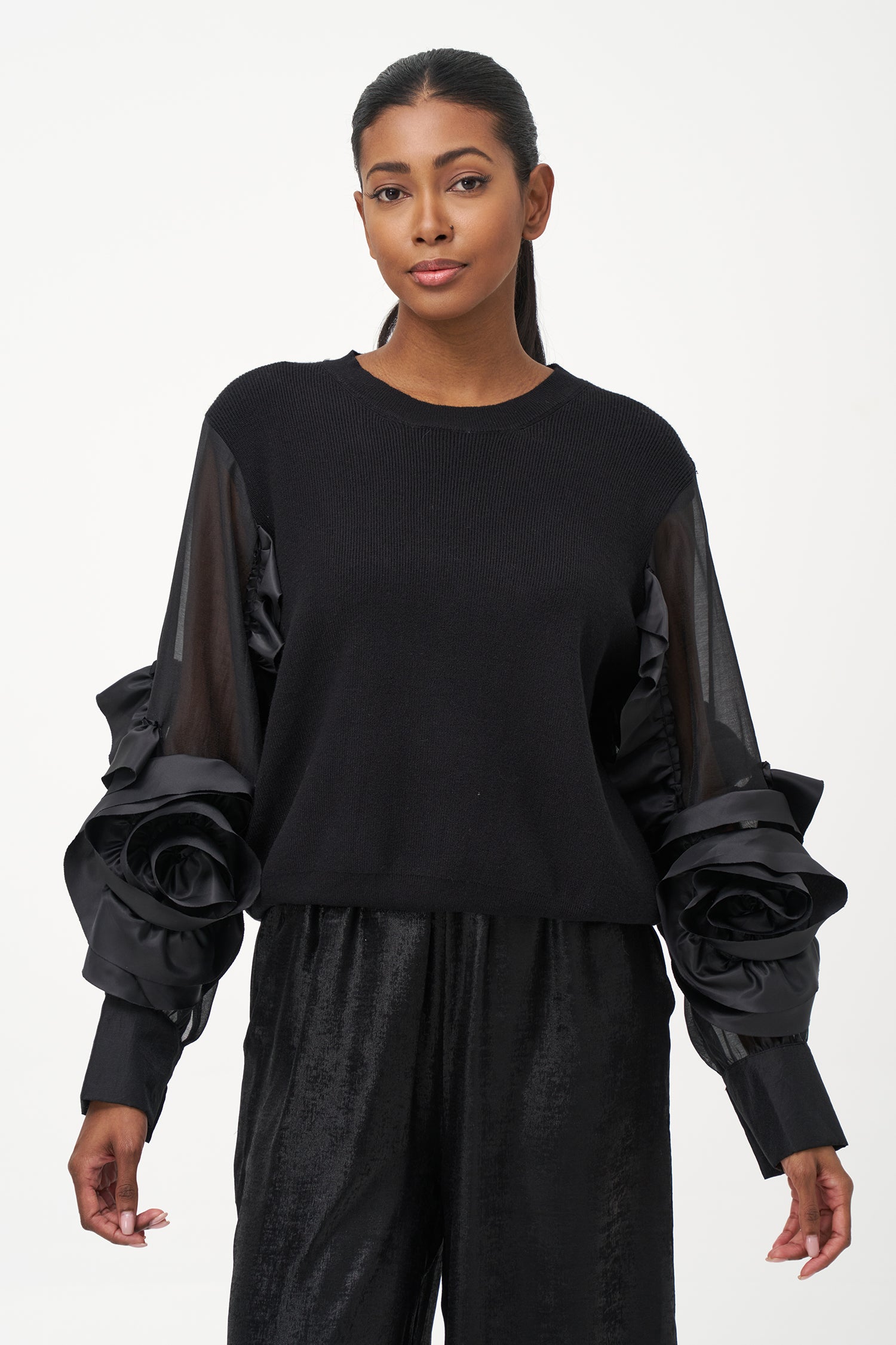 Black crew neck sweater with statement ruffled satin sleeves and contrast textures for a bold, fashion-forward silhouette.