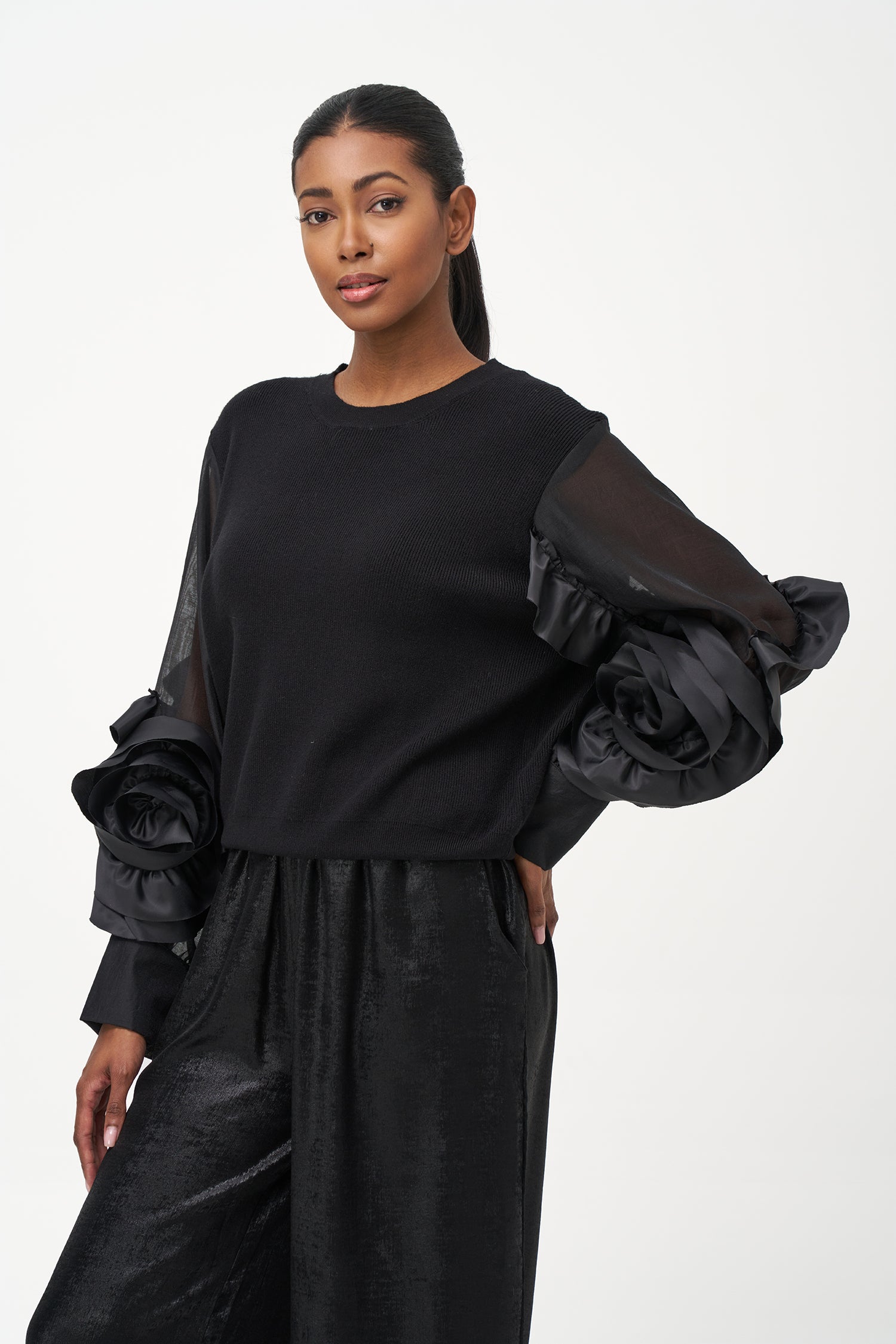 Black crew neck sweater with statement ruffled satin sleeves and contrast textures for a bold, fashion-forward silhouette.