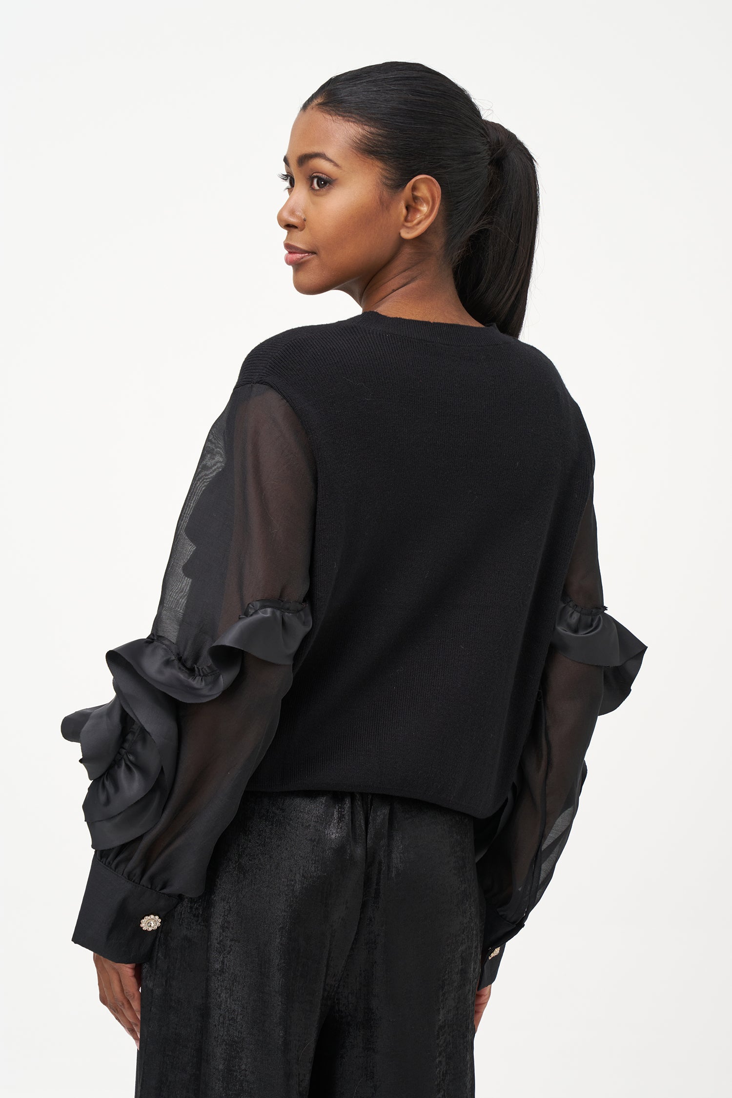 Black crew neck sweater with statement ruffled satin sleeves and contrast textures for a bold, fashion-forward silhouette.