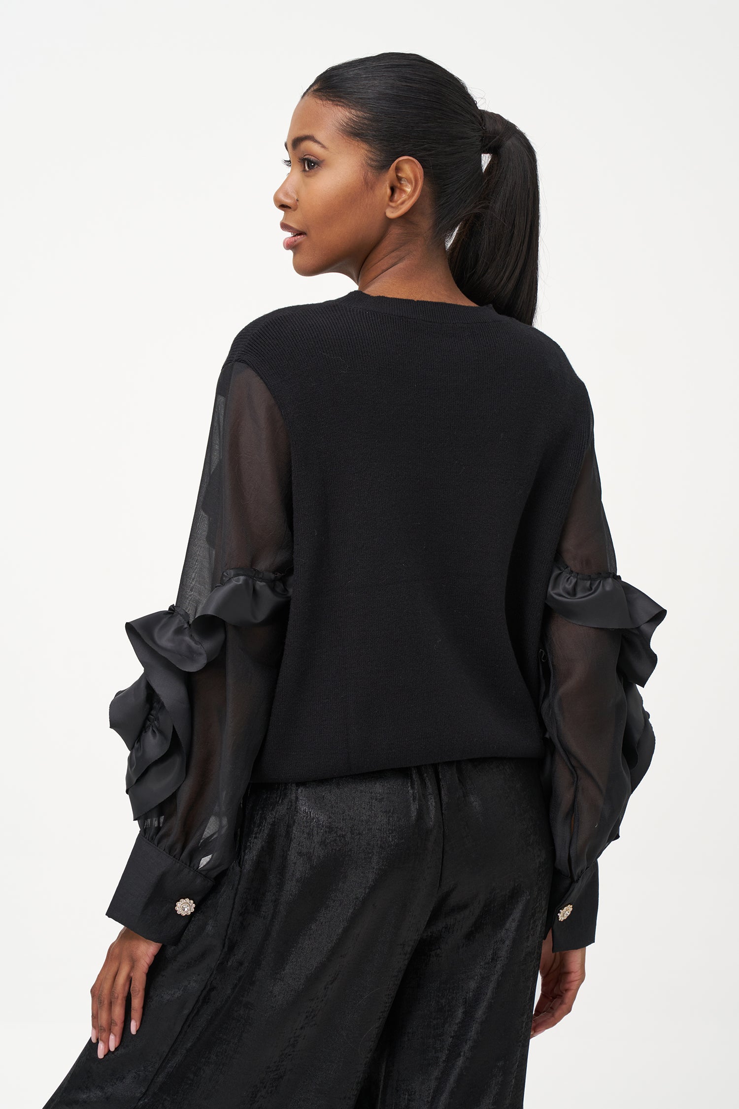 Black crew neck sweater with statement ruffled satin sleeves and contrast textures for a bold, fashion-forward silhouette.