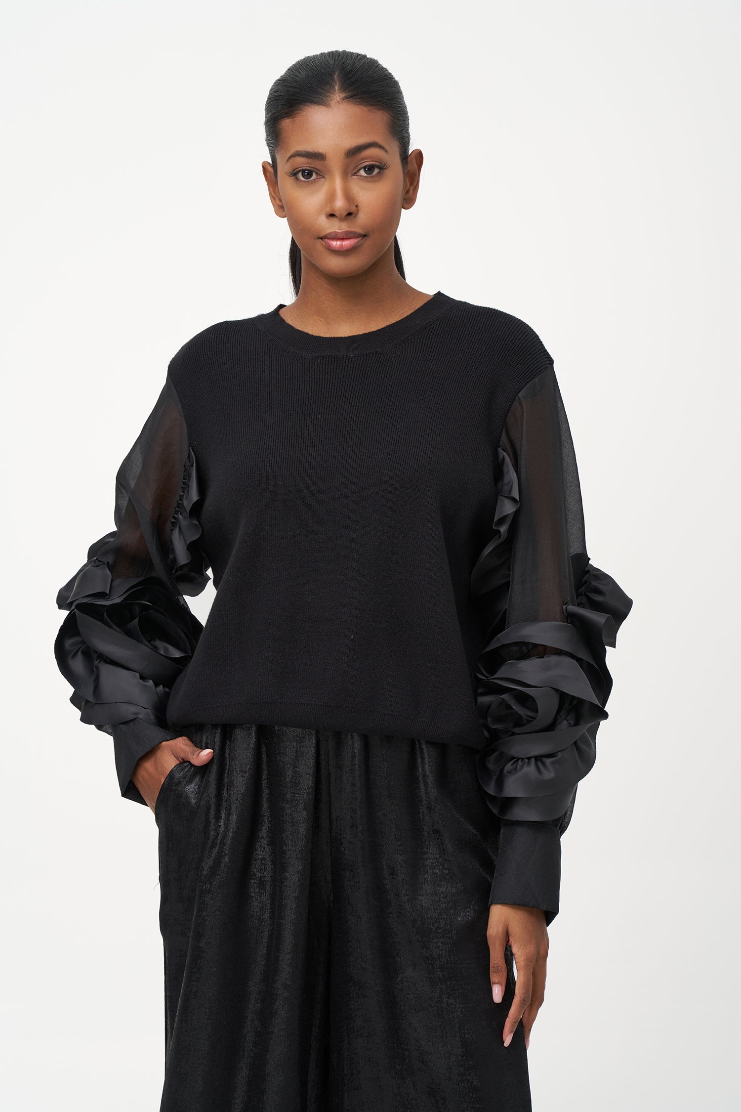 Black crew neck sweater with statement ruffled satin sleeves and contrast textures for a bold, fashion-forward silhouette.