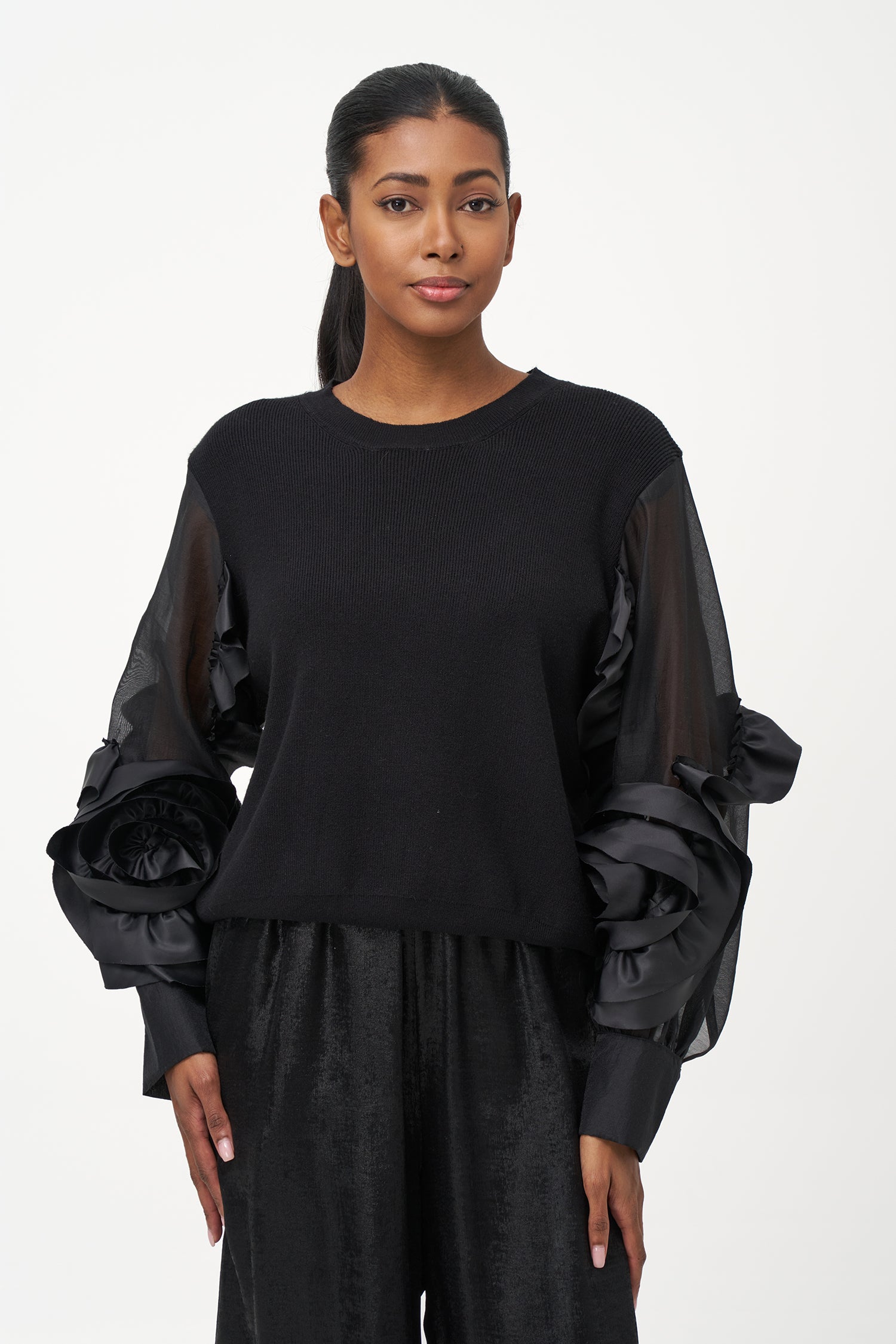 Black crew neck sweater with statement ruffled satin sleeves and contrast textures for a bold, fashion-forward silhouette.