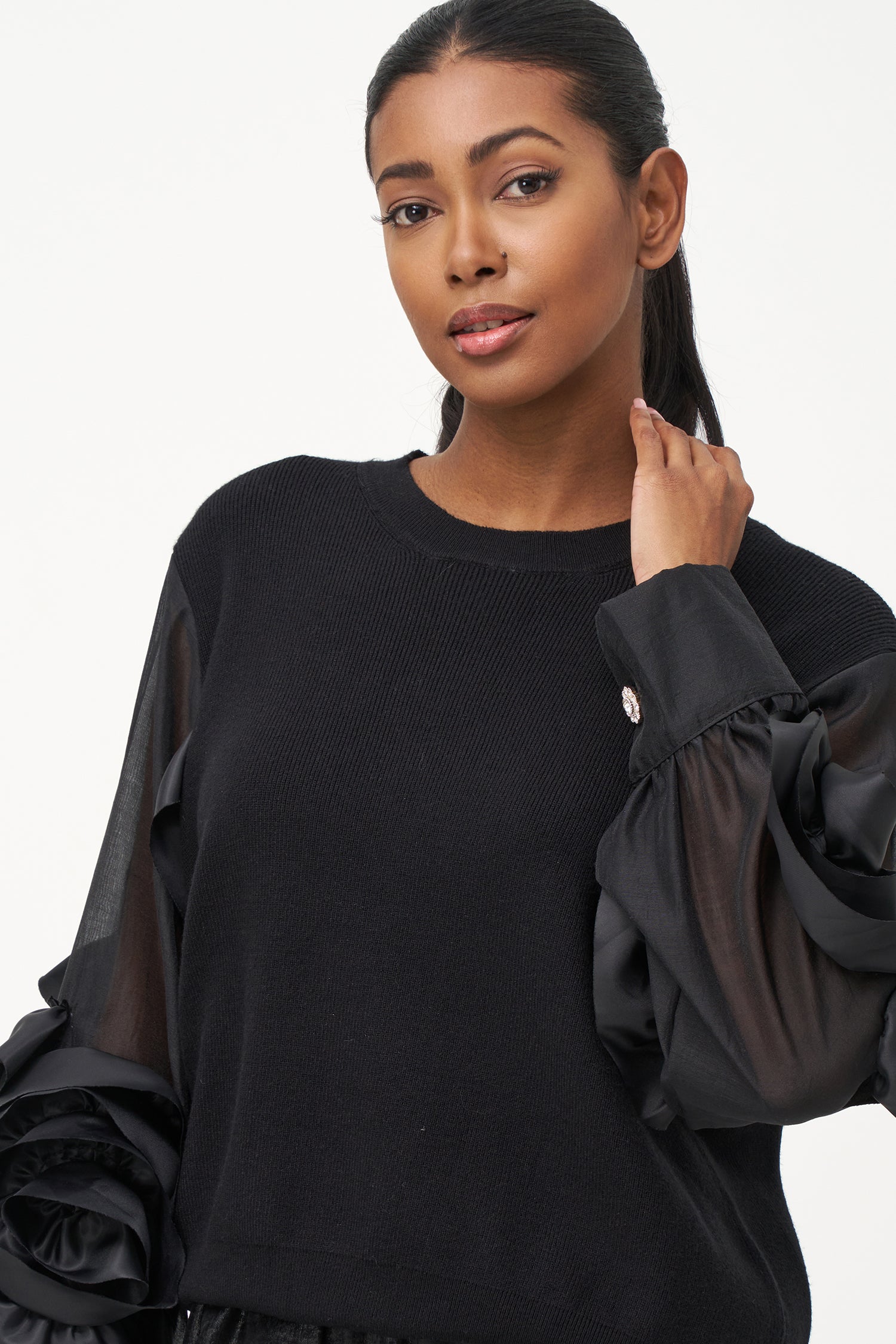 Black crew neck sweater with statement ruffled satin sleeves and contrast textures for a bold, fashion-forward silhouette.
